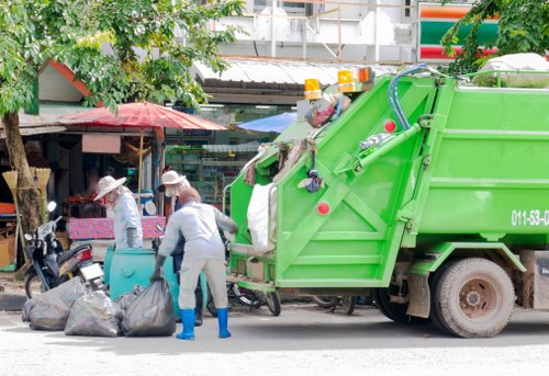 Experienced gardeners clearing a lush garden